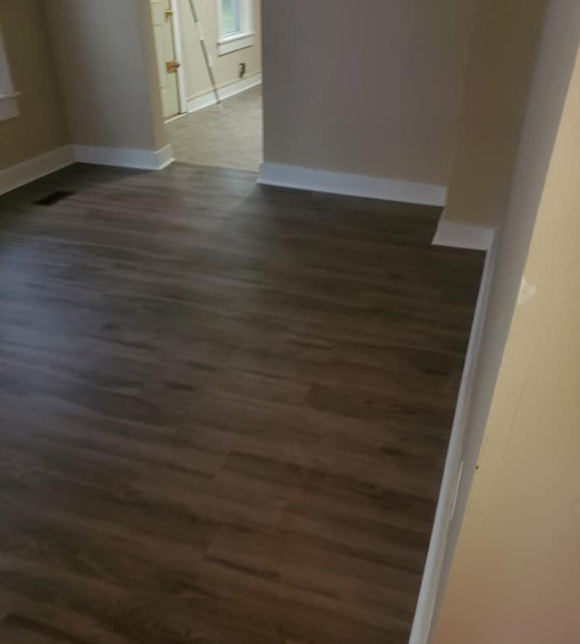 Dark vinyl plank flooring installed in a home