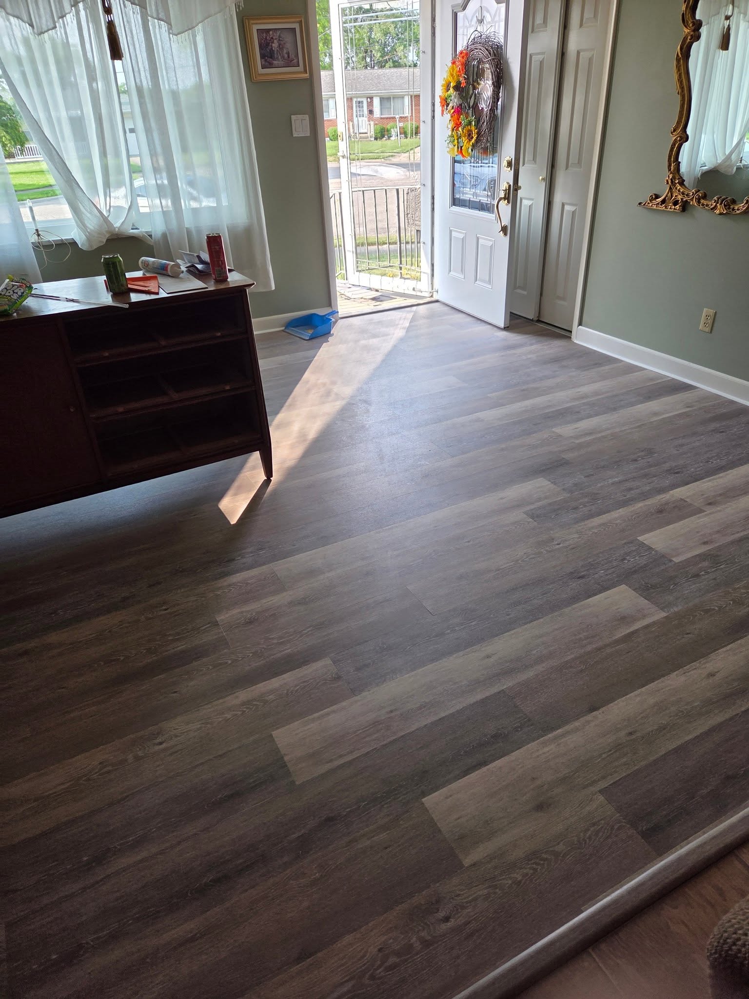 Gray vinyl plank flooring installed by the front entry
